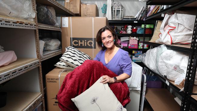 Manuela Whitford with goods at the charities storage shed. Picture: Glenn Hampson