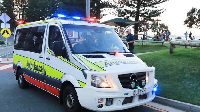 March 13, Rainbow Bay, Coolangatta, Gold Coast - Queensland Ambulance Officers interview witnesses to a mistaken report of a shark attack which turned out to be a self inflicted Surfing Fin Chop.Picture Scott Powick Newscorp