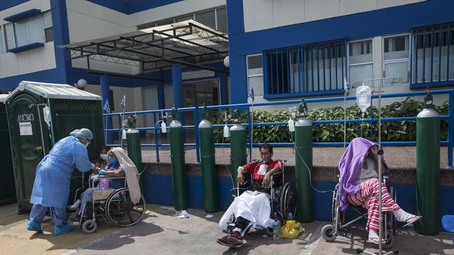 People infected with COVID-19 disease wait for an available bed, outside a public hospital in Lima, Peru. Picture; AP.