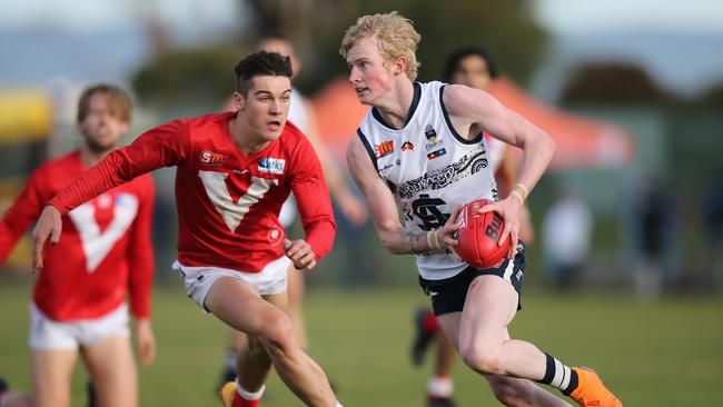 South's Mark Noble gets away from North's Connor Rozee at Noarlunga Oval. Picture: AAP Image/Dean Martin