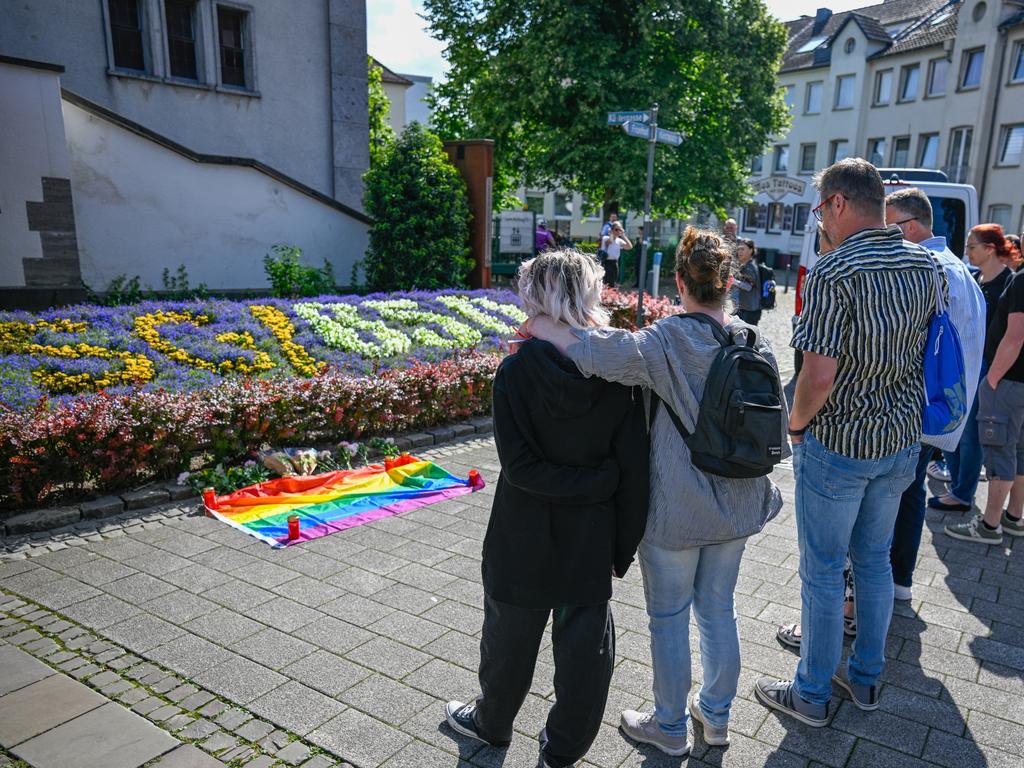 Mourners pay tribute to the dead after a knife-wielding assailant reportedly stabbed people at random during a public celebration. Picture: Sascha Schuermann/Getty Images.