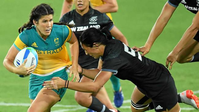 Australia's Charlotte Caslick is tackled by Sarah Goss of New Zealand in the Women's Rugby Sevens at the Rio 2016 Olympic Games. Picture: DEAN LEWINS