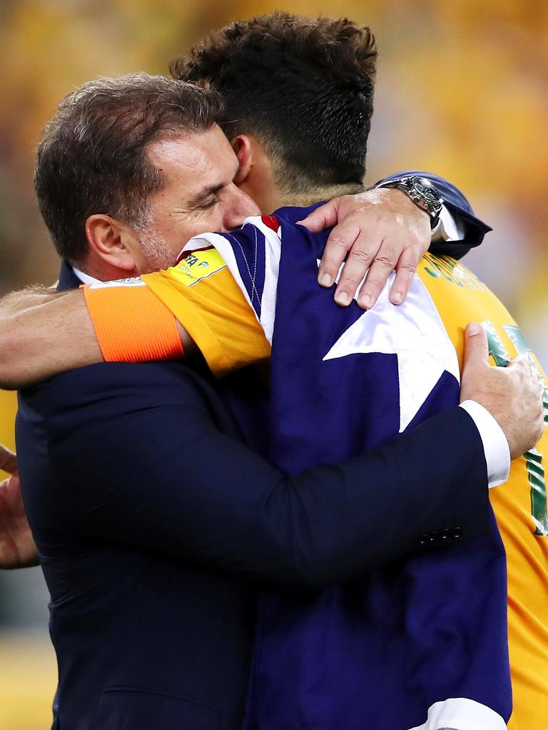 Postecoglou embraces Mile Jedinak after a Socceroos match.