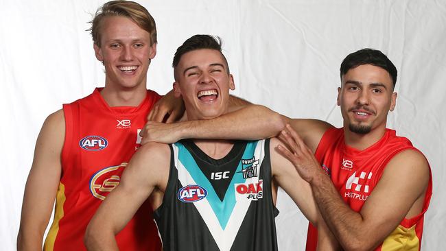 Gold Coast’s Jack Lukosius and Izak Rankine with Port Adelaide’s Connor Rozee. Picture: Michael Klein