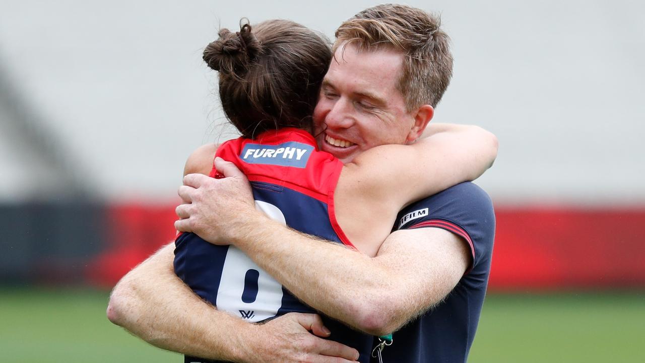 Daisy Pearce embraces Demons AFLW coach Mick Stinear.