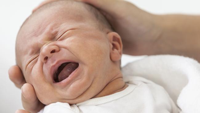 Father Parent Holding Crying Screaming Baby. Thinkstock image 159044036