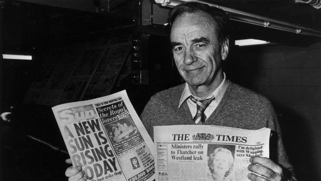 Rupert Murdoch holds up editions of The Sun and The Times newspapers at their production centre in London in 1986.