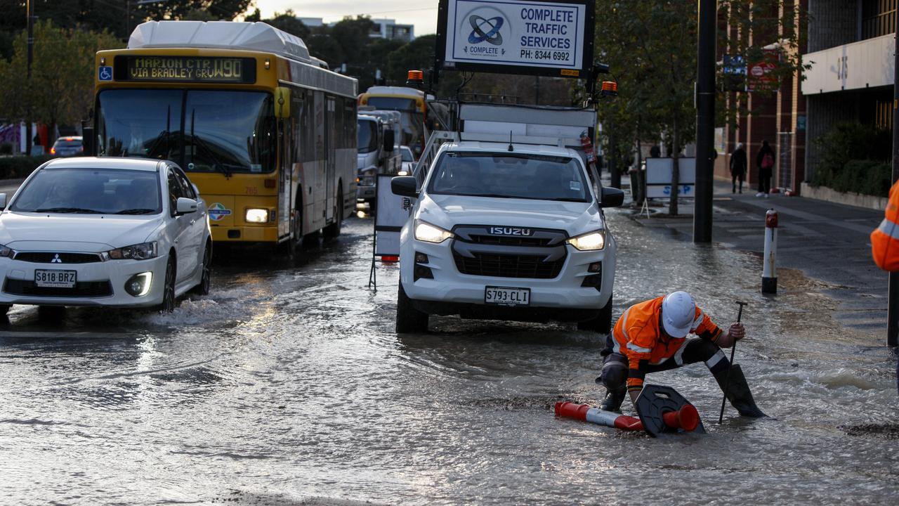 A burst water main at the intersection of North Terrace and Frome Rd in June. SA Water defended incentive payments. Picture: Brett Hartwig
