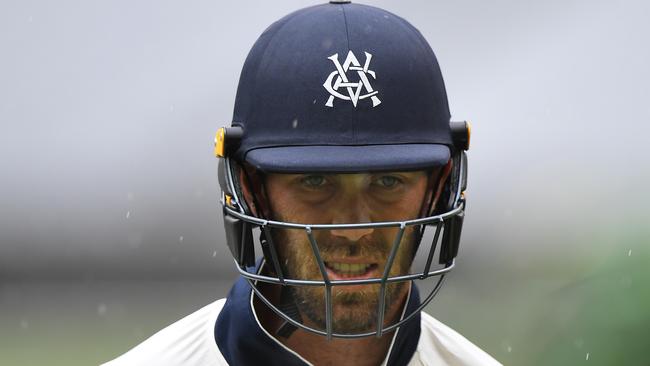 Glenn Maxwell walks off a rain-soaked MCG.