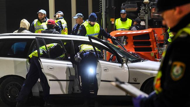 Police in Albury search a car crossing the state border from Victoria. Picture: William West/AFP