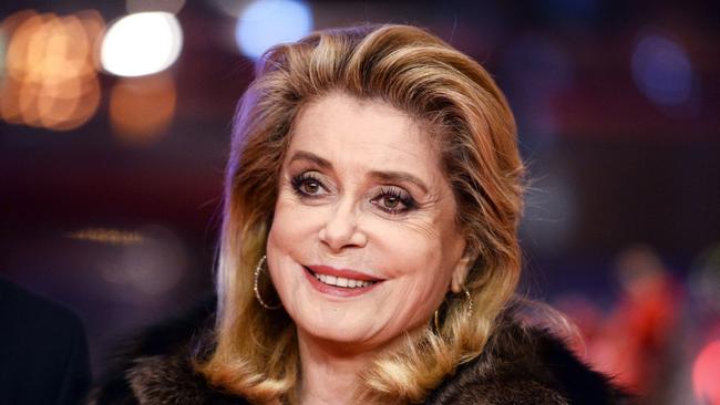 (FILES) This file photo taken on February 14, 2017 shows French actress Catherine Deneuve posing on the red carpet for the premiere of the film "Sage Femme" (The Midwife) in competition at the 67th Berlinale film festival in Berlin.   France's most revered actress Catherine Deneuve hit out on January 9, 2018 at a new "puritanism" sparked by sexual harassment scandals, declaring that men should be "free to hit on" women. / AFP PHOTO / dpa / Gregor Fischer / Germany OUT