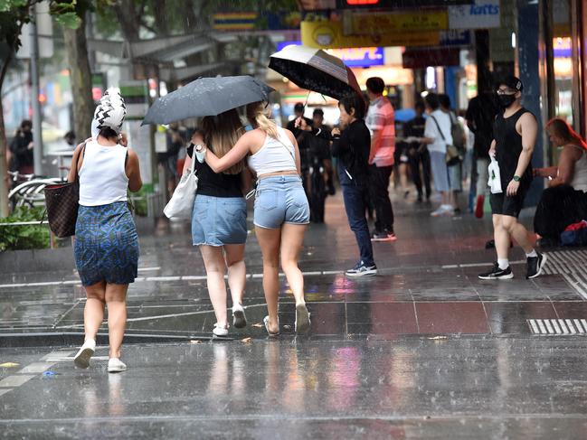 Pedestrians run for cover in Melbourne’s CBD. Picture: Nicki Connolly