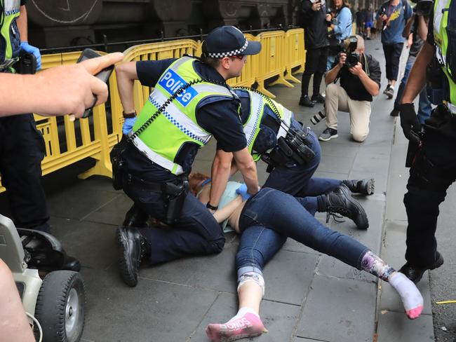 Police arrest a person after the scenes turned fiery. Picture: Alex Coppel.