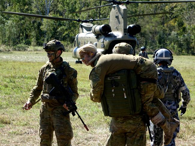 Casualties are carried to an awaiting helicopter. Picture: Major Al Green