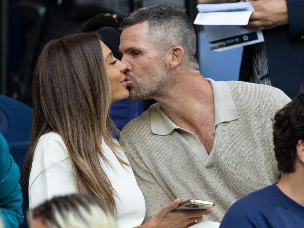Nadia Bartel and Peter Dugmore share a kiss during the Djokovic vs Prizmic match. Picture: Fiona Hamilton/Tennis Australia