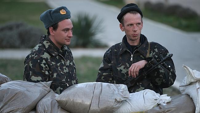 Ukrainians stand guard at the Belbek military base in Lubimovka, Ukraine. 