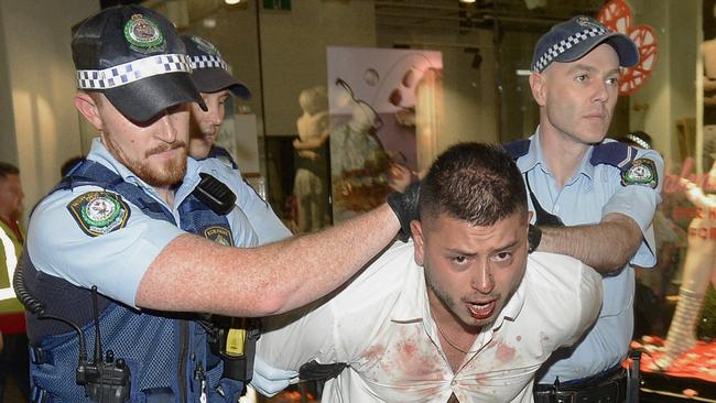 Police escort a man out of Ivy nightclub and to a caged police truck after a report of a fight between two men. Picture: Gordon McComiskie