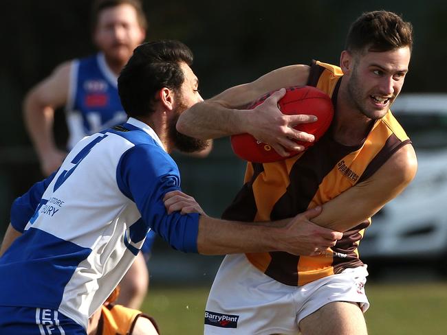 Heath McKerchar of Hadfield is tackled by Matt Welsh of Sunbury during EDFL footy: Sunbury Kangaroos v Hadfield on Saturday, July 6, 2019, in Sunbury, Victoria, Australia. Picture: Hamish Blair