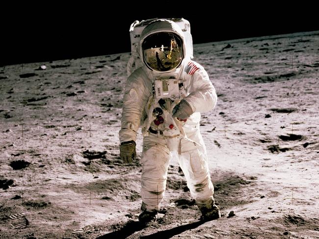 This photo obtained from NASA and taken by Neil Armstrong (reflected on helmet) shows Edwin "Buzz" Aldrin walking on the Moon on July 20, 1969. - When the Saturn V rocket built by Wernher von Braun launched with the Apollo 11 capsule at its summit on July 16 1969, one million people flocked to watch the spectacle on the beaches of Florida near Cape Canaveral. But many had doubts that they'd succeed in landing this time. (Photo by Neil ARMSTRONG / NASA / AFP) / **RESTRICTED TO EDITORIAL USE - MANDATORY CREDIT "AFP PHOTO / NASA" - NO MARKETING - NO ADVERTISING CAMPAIGNS - DISTRIBUTED AS A SERVICE TO CLIENTS **TO GO WITH AFP STORY by Ivan Couronne, "To the Moon and back: mankind's giant leap 50 years on"