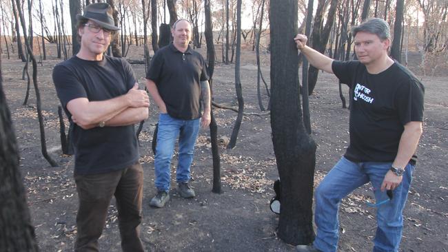 Wagga band Bitter Shoosh — Scott Cochrane, Troy Obrien and Jase Ip — on the fire ground during the shooting of a music video to raise funds for bushfire-affected communities. Picture: Supplied