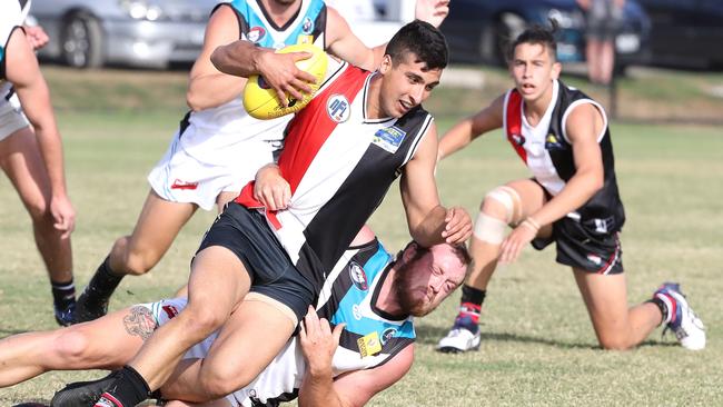 Watsonia’s Adrian Alfonsi can’t escape the tackle.