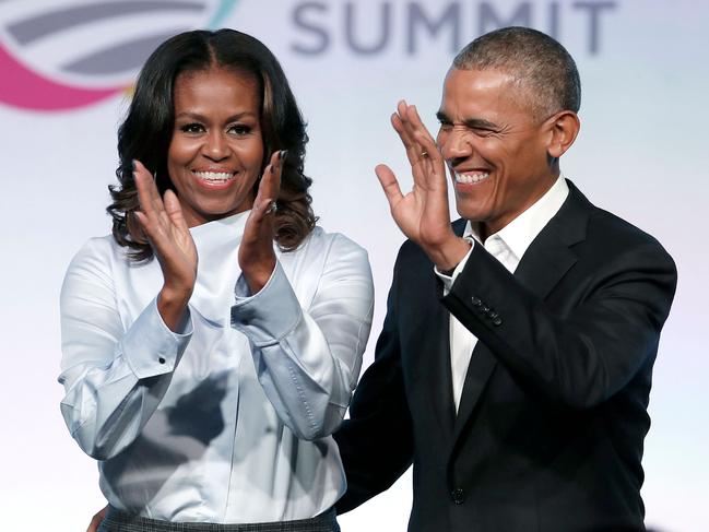 (FILES) In this file photo taken on October 31, 2017, former US President Barack Obama and his wife Michelle arrive at the Obama Foundation Summit in Chicago, Illinois. - Michelle Obama says she can "never forgive" Donald Trump for questioning her husband's American citizenship, saying he and other "birthers" put her family at risk, in her hotly anticipated new memoir. Obama also says she was surprised that so many American women voted for the "misogynist" Trump over Hillary Clinton, "an exceptionally qualified female candidate," in the 2016 election. The book, "Becoming," hits stores on November 13, 2018. (Photo by Jim Young / AFP)