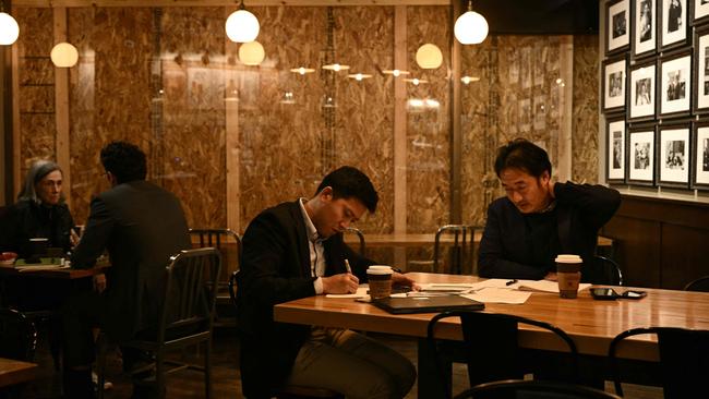 Patrons sit in a boarded up Peet's coffee shop in downtown Washington, DC, on November 4, 2024, ahead of possible violence on and after the November 5 election. Picture: Brendan SMIALOWSKI / AFP