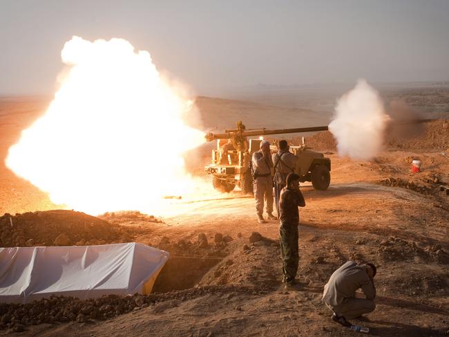 Iraqi Kurdish Peshmerga fighters fire a recoilless rifle towards Islamic State fighters. AFP PHOTO/ JM Lopez