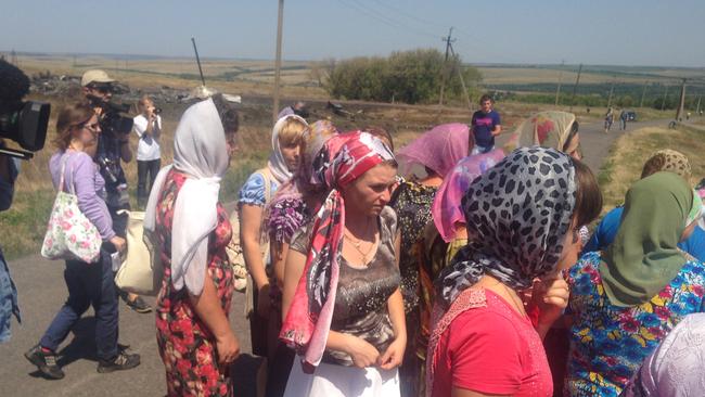 Photo showing people gathering near the MH 17 crash site for a memorial procession to honour the dead. Photographer: Paul Toohey