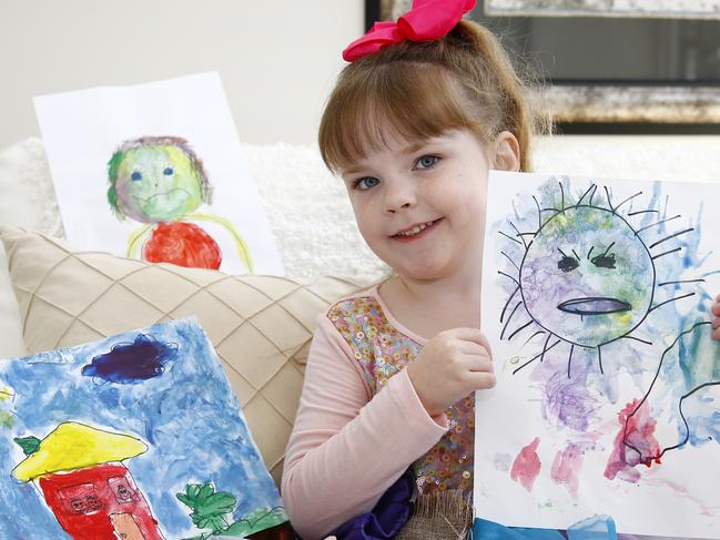 Four year old Tara Clements with her paintings. Picture: Tertius Pickard