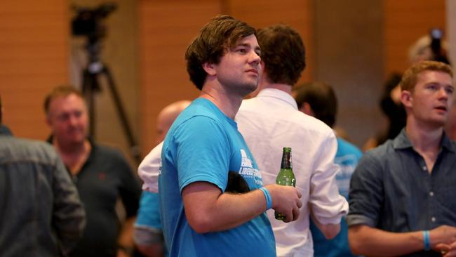 Not much to cheer about … a young NSW Liberal supporter drinks a beer at the party’s election night function at the Hilton Hotel, Sydney CBD. Picture: Damian Shaw