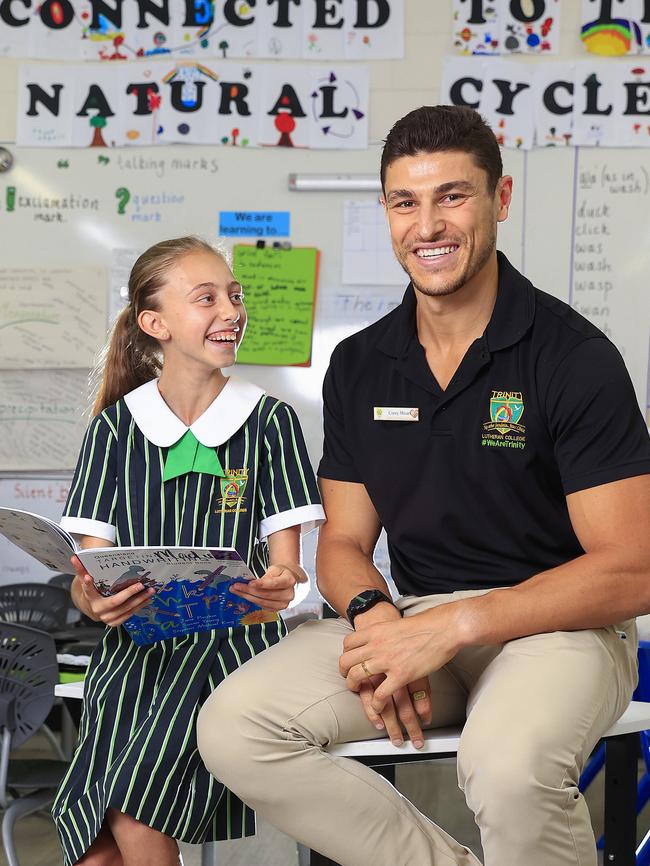 Corey Micari from Trinity Lutheran College. He's a Year 5 teacher and ex footballer. With student Kayla Hansmeyer 10. Pics Adam Head