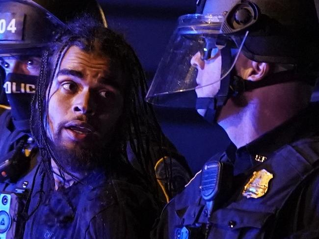 WASHINGTON, DC - JUNE 01: A protestor is arrested by Metropolitan Police officers during a protest on June 1, 2020 in Washington, DC. Protests and riots continue in cities across America following the death of George Floyd, who died after being restrained by Minneapolis police officer Derek Chauvin. Chauvin, 44, was charged last Friday with third-degree murder and second-degree manslaughter..   Drew Angerer/Getty Images/AFP == FOR NEWSPAPERS, INTERNET, TELCOS & TELEVISION USE ONLY ==