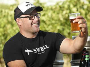 Dan Wright - owner, brewer and consultant - of Swell Brewing Co- pictured with some of his products, at his McLaren Vale home.picture: Bianca De Marchi