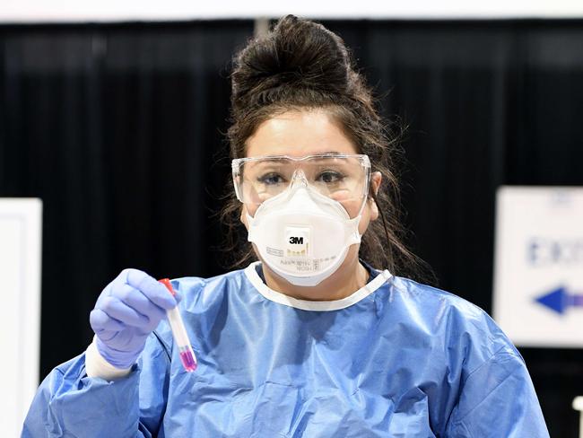 A medical worker gets blood from US patients. Picture: Getty Images/AFP