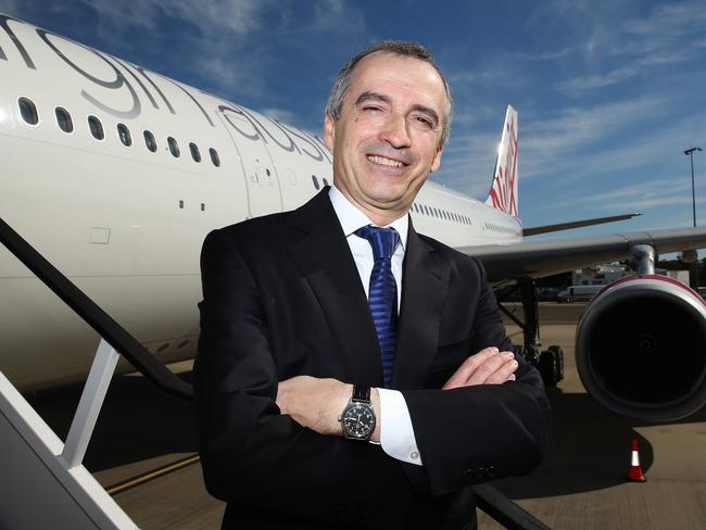 John Borghetti, chief executive officer of Virgin Australia Holdings Ltd., poses for a photograph in front of an Airbus SAS A330 aircraft in Sydney, Australia, on Monday, Aug. 17, 2015. Virgin Australia launched its new business-class suites for its A330 fleet. Photographer: Brendon Thorne/Bloomberg *** Local Caption *** John Borghetti