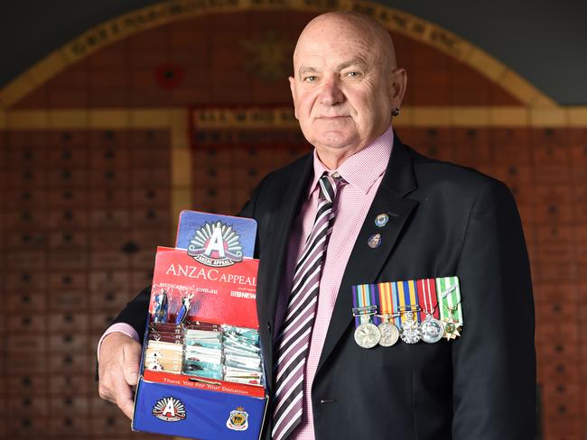 Greensborough RSL President Lee Webb with Anzac badges which will be sold at the sub-branch leading up to Anzac Day. Picture: Lawrence Pinder