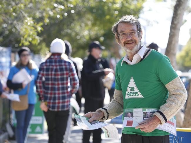 A Green's volunteer and former candidate for North Sydney Ted Nixon hands out how to vote cards for Dr Arthur Chesterfield-Evans.