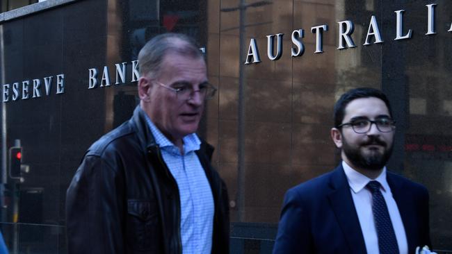 People walk past the Reserve Bank of Australia building in Sydney. Picture: AAP