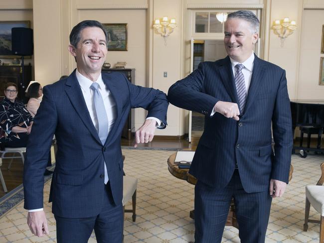 Senator Simon Birmingham and Mathias Cormann elbow bump at the Government House ceremony. Picture: NCA NewsWire / Gary Ramage