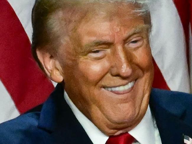 TOPSHOT - Former US President and Republican presidential candidate Donald Trump points to his wife former US First Lady Melania Trump during an election night event at the West Palm Beach Convention Center in West Palm Beach, Florida, early on November 6, 2024. (Photo by Jim WATSON / AFP)