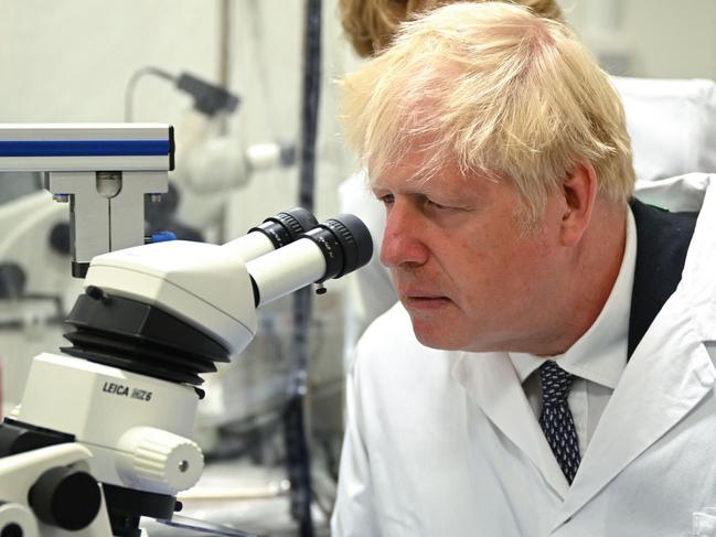 Britain's Prime Minister Boris Johnson looks through a microscope during a visit to the Francis Crick Institute in London. Picture: AFP