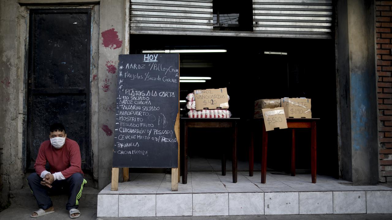 A man sits as he offers food for sale during a government-ordered lockdown at a slum in Buenos Aires, Argentina on Sunday, April 26, 2020. Picture: Natacha Pisarenko/AP