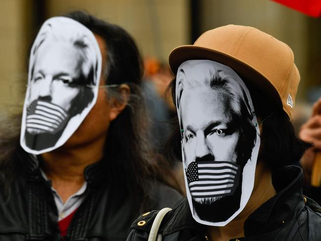 Demonstrators protest with masks of WikiLeaks founder Julian Assange during a Pro-Assange demo at Brandenburg Gate in Berlin. Picture: AFP