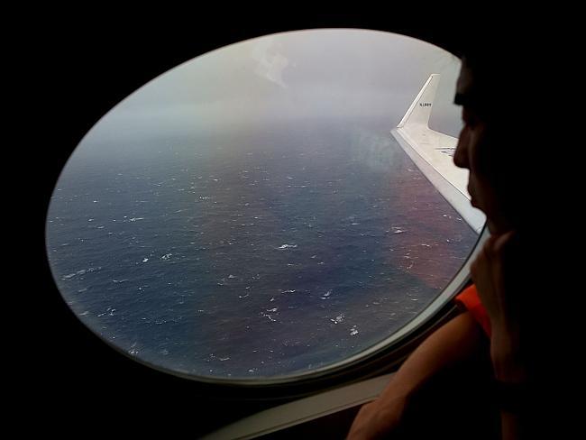 Lookout ... a Japanese Coast Guard keeps watch for Malaysia Airlines Flight MH370 debris over the Indian Ocean. 