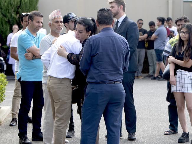 4/1/19 - Memorial of Nischal Ghimire who drowned in waters near Glenelg last week. Nischal Ghimire's brother Ghanashyam Ghimire is given a hug after the viewing. Photo - Naomi Jellicoe