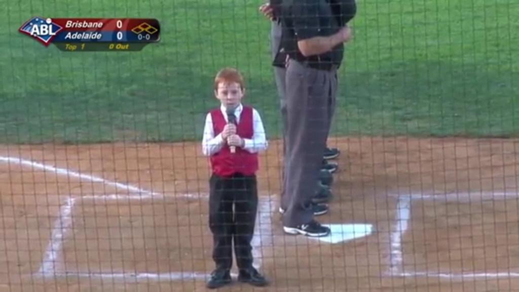 Kid battles hiccups while singing the national anthem