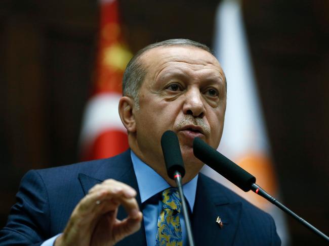 TOPSHOT - This handout photo released by Turkish President Office shows Turkish President and leader of Turkey's ruling Justice and Development (AK) Party Recep Tayyip Erdogan  speaking during his party's parliamentary group meeting at the Grand National Assembly of Turkey in Ankara, on October 23, 2018. - Turkish President Recep Tayyip Erdogan called for 18 Saudi suspects in the murder of journalist Jamal Khashoggi to stand trial in Istanbul, saying all those involved had to face punishment. (Photo by KAYHAN OZER and HO / TURKISH PRESIDENT OFFICE / AFP) / RESTRICTED TO EDITORIAL USE - MANDATORY CREDIT "AFP PHOTO / TURKISH PRESIDENT OFFICE / KAYHAN OZER" - NO MARKETING NO ADVERTISING CAMPAIGNS - DISTRIBUTED AS A SERVICE TO CLIENTS