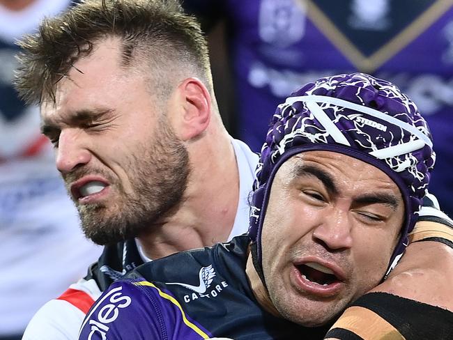 MELBOURNE, AUSTRALIA - AUGUST 26:  Jahrome Hughes of the Storm is tackled Angus Crichton of the Roostersduring the round 24 NRL match between the Melbourne Storm and the Sydney Roosters at AAMI Park on August 26, 2022, in Melbourne, Australia. (Photo by Quinn Rooney/Getty Images)