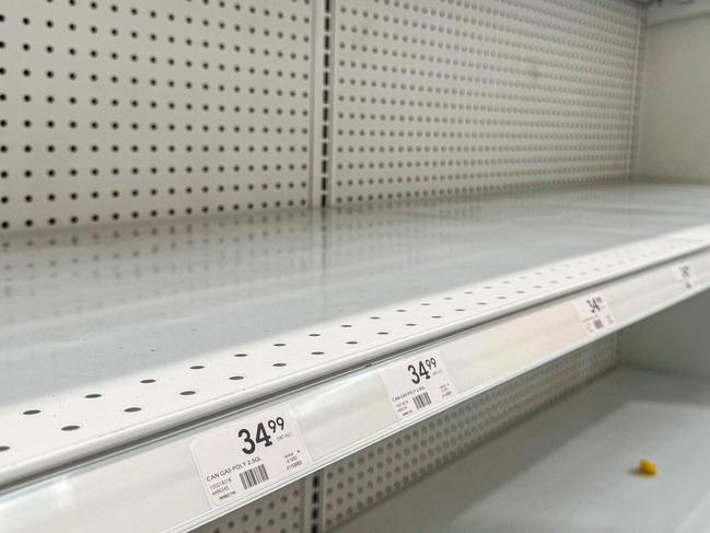 Empty shelves where jerry cans were for sale are seen at a hardware store as people prepare for the arrival of Hurricane Beryl in Barbados. (Photo by CHANDAN KHANNA / AFP)